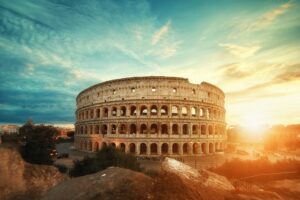 Beautiful shot of the famous Roman Colosseum amphitheater under the breathtaking sky at sunrise