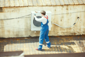 HVAC technician working on a capacitor part for condensing unit