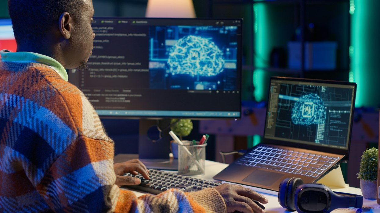 Black man programmer manages code and scripts in artificial intelligence