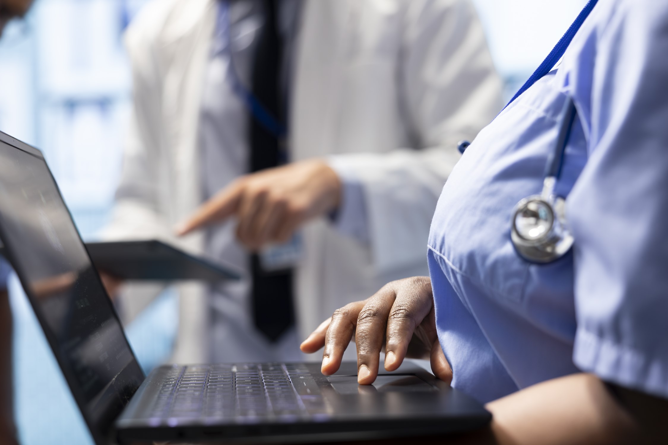 Doctor consulting with his team to examine x ray test results in office